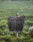 rustic fire put basket in field.