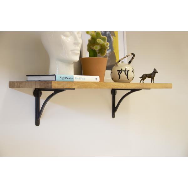 Wooden shelf with two steel shelf brackets.