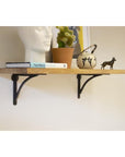 Wooden shelf with two steel shelf brackets.