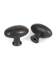 Pair of beeswax oval cabinet knobs.