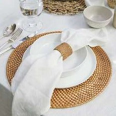 White linen napkin on white dinnerware with natural brown accessories.