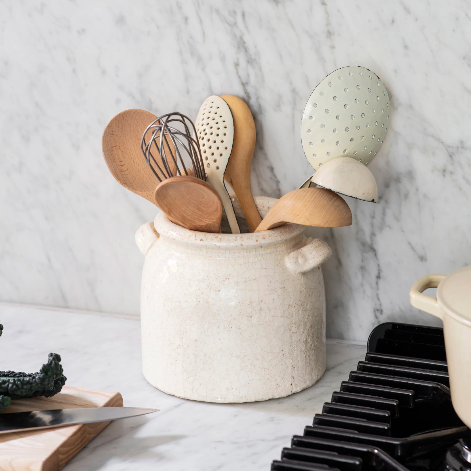 Belle Ceramic Utensil Holder on white marble countertop with wooden and metal utensils.