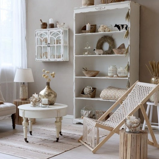 White bookshelf with neutral ornaments in living room.