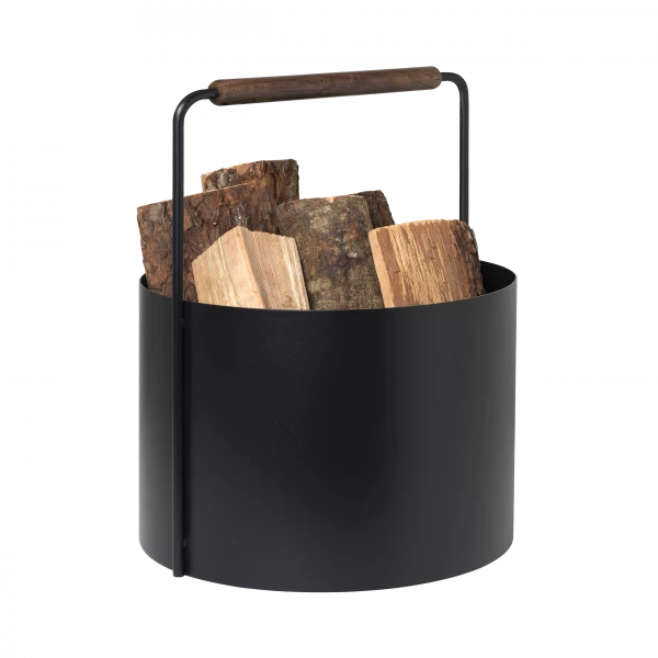 Blomus ASHI black firewood basket with brown handle and logs inside. 