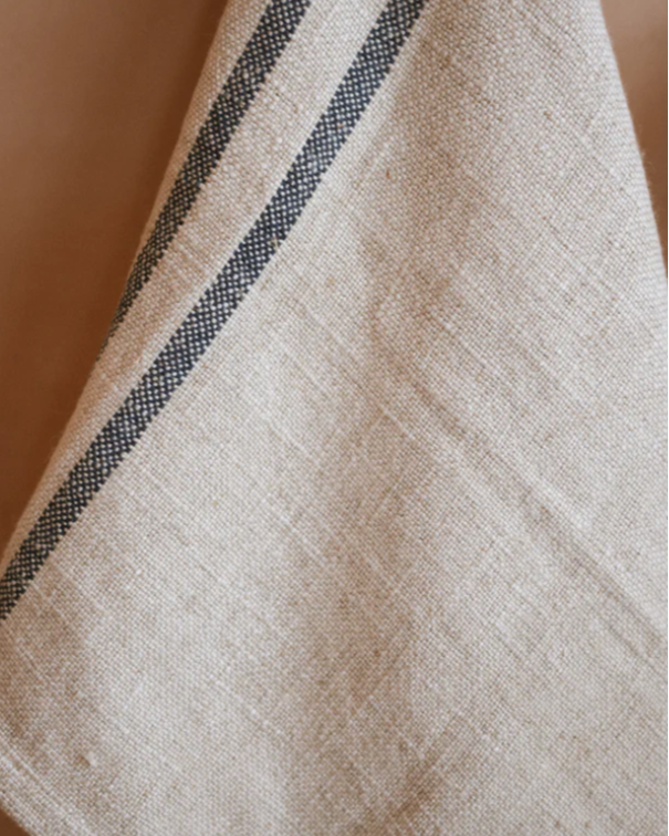 Close up of texture on cream and blue striped kitchen towel.