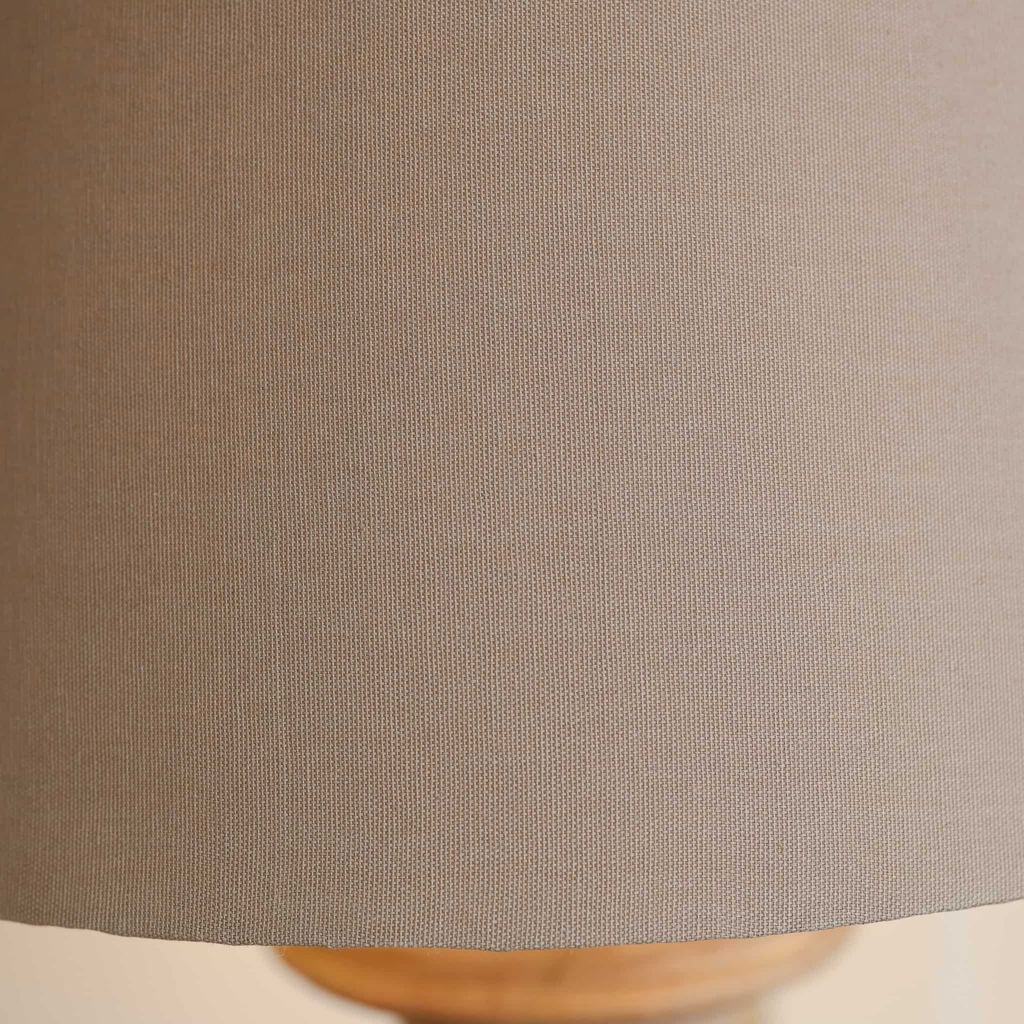 Close up of textured beige linen lamp shade.
