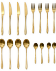 16 piece brass cutlery set laid out.