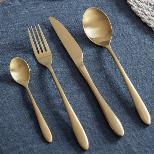 Brass cutlery set with fork, knife, spoon and teaspoon.