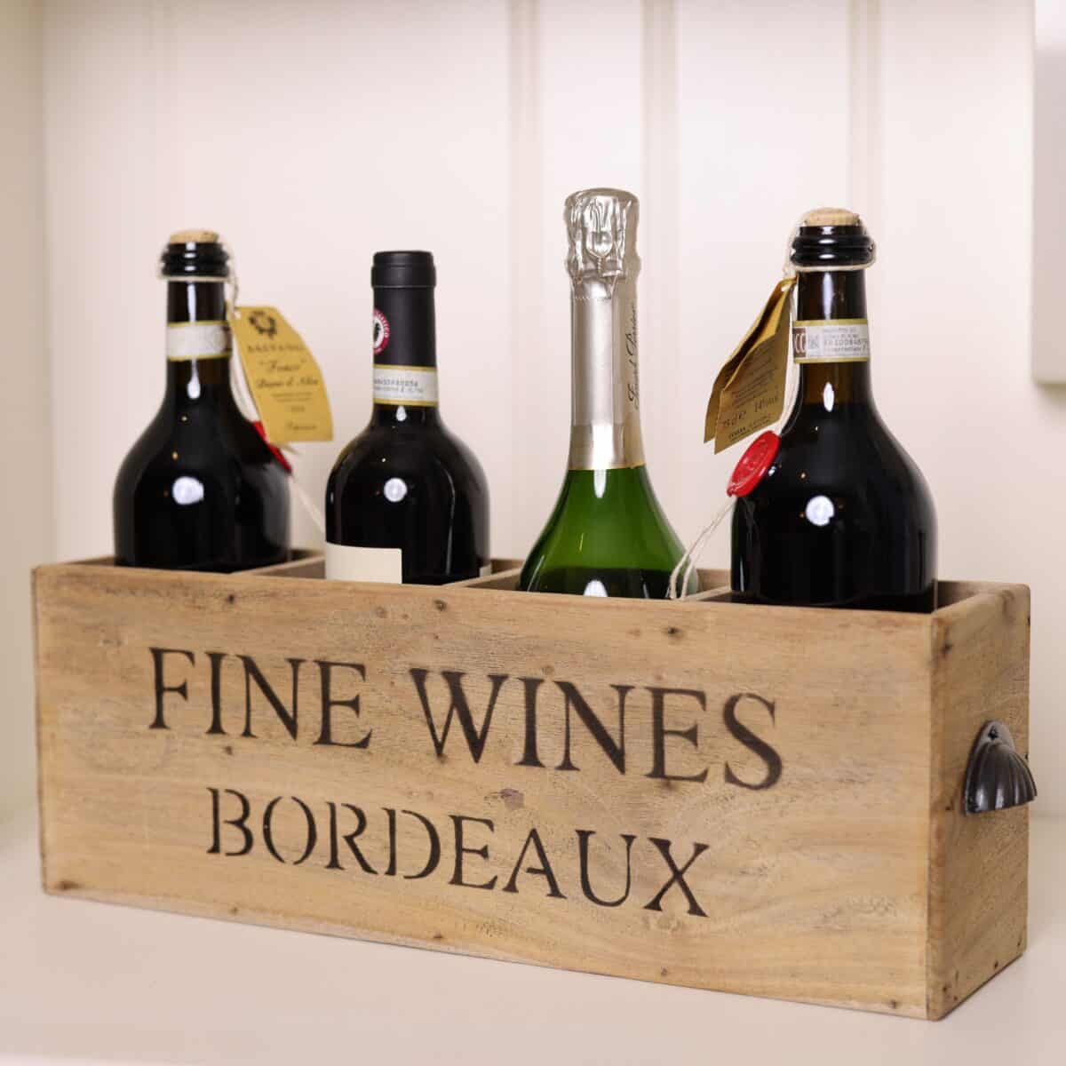 Bordeaux wooden vintage wine crate with 4 bottles inside. 