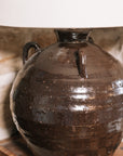 Detailed shot of the Large brown Table Lamp With Linen Shade on wooden chess board against stone wall. 