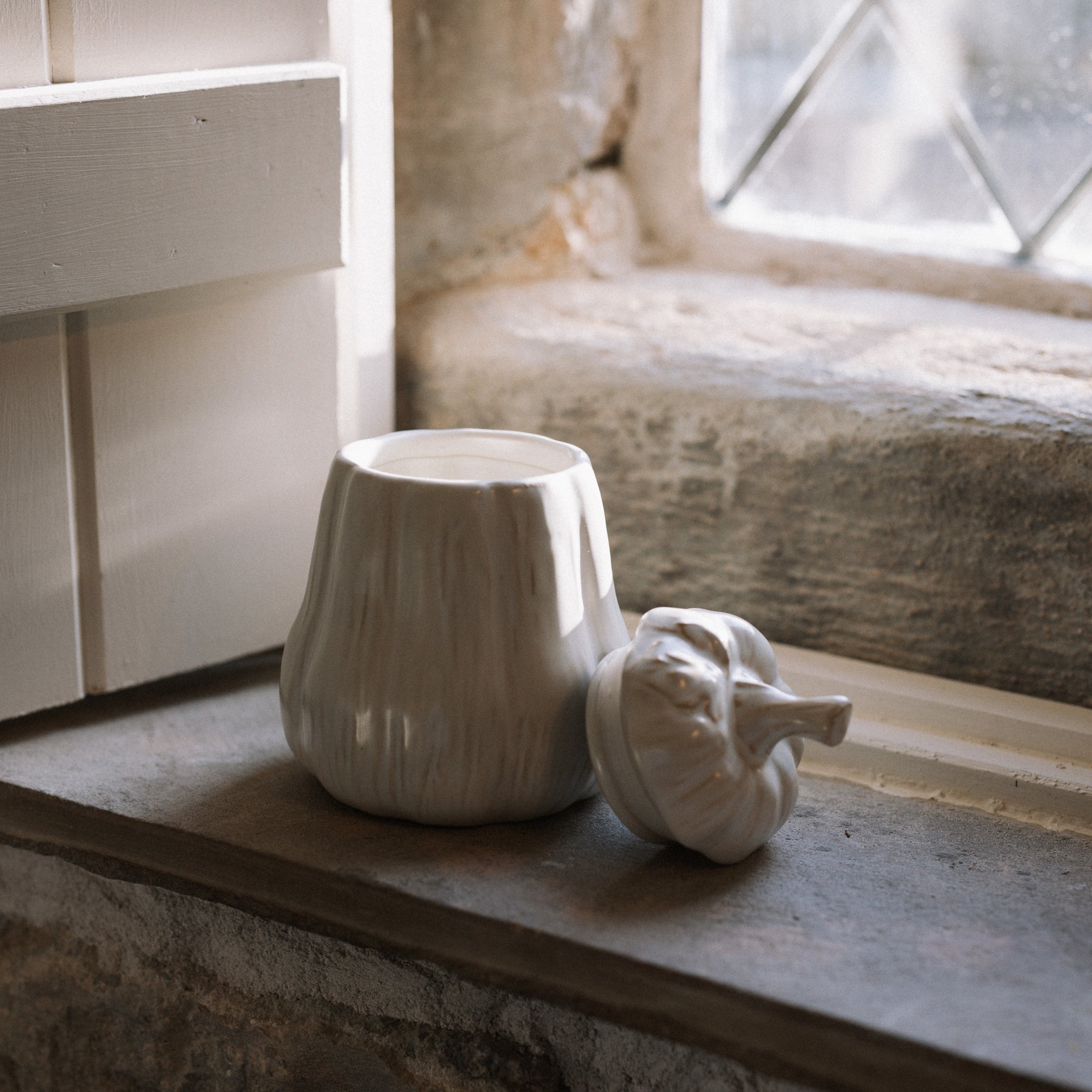 Butternut squash Jar with Lid on stone windowsill.