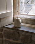 Butternut squash Jar with Lid on stone windowsill with wooden shutter.