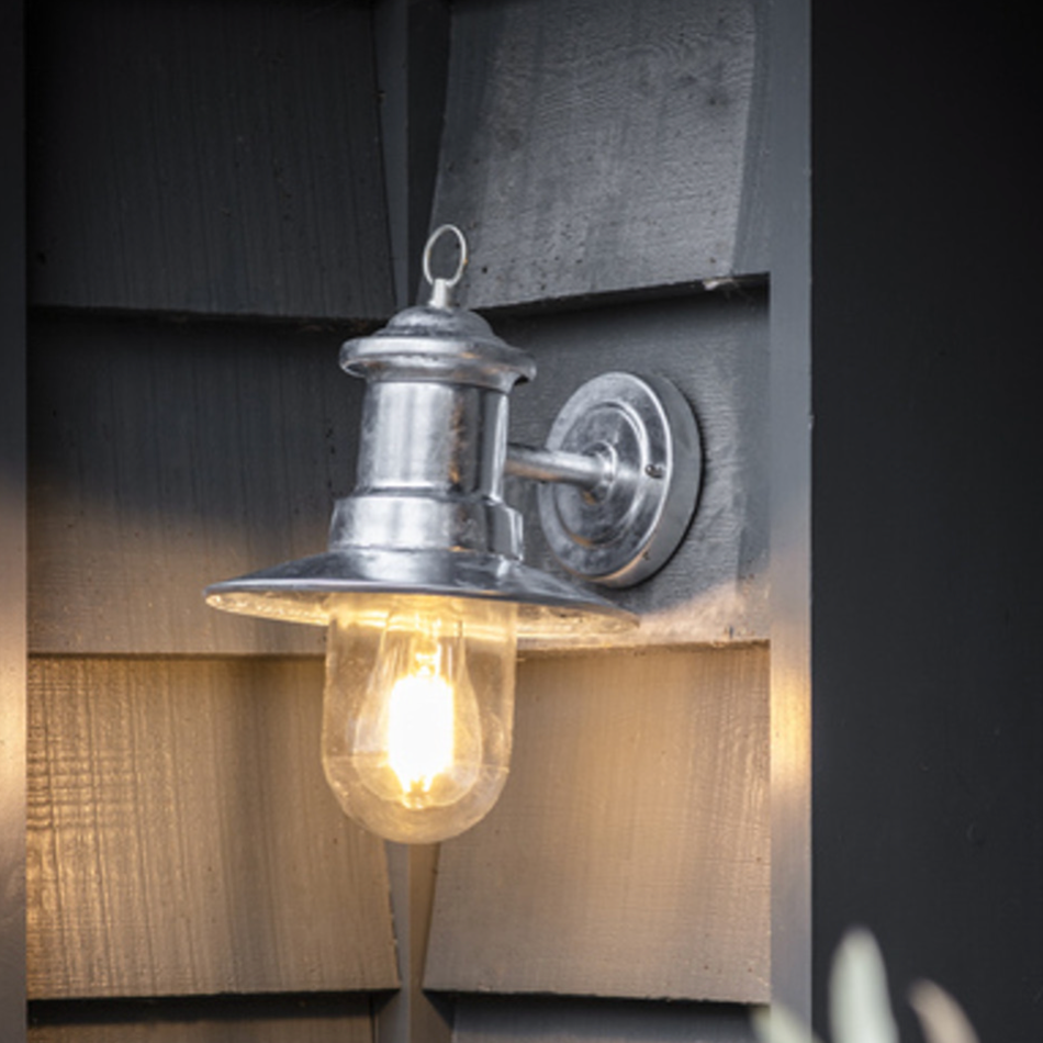 silver outdoor wall light on wooden wall.