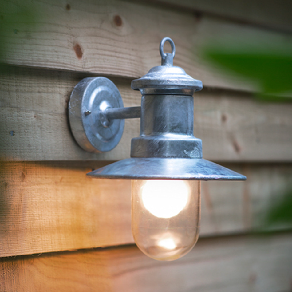 silver outdoor wall light on wooden wall.