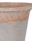 Close up of red antiqued stone plant pot.