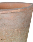 Close up of red antiqued stone plant pot.