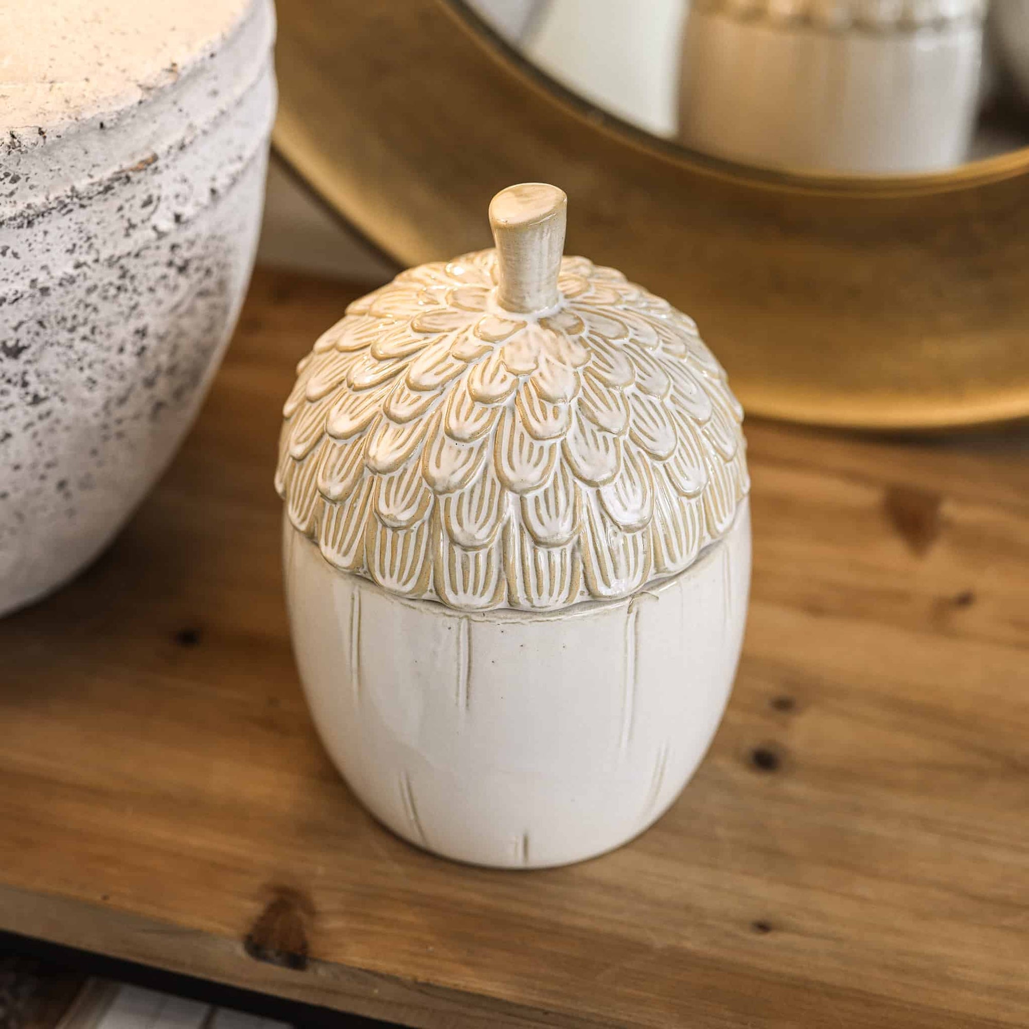 Close up of ceramic acorn storage jar.