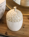 Close up of ceramic acorn storage jar.