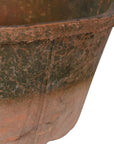 Close up of antiqued red stone planter.