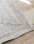 natural jute rug on wooden floor.