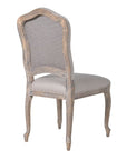 French stone coloured upholstered dining chair from the back.