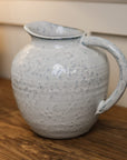 Small ceramic jug with blue speckled glaze.
