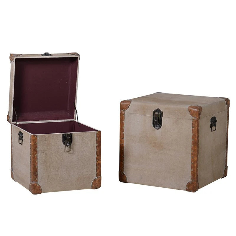 Set of two linen storage trunks with faux leather panelling.