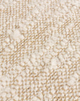 Close up of rustic woven bouclé rectangle natural cushion .