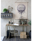 Wooden desk with brass accents in office with other decor.