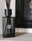 Extra large sences reed diffuser on stone mantle with black painting.