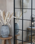 Fleur dried pampas grass in a large gray vase with mirror and light.