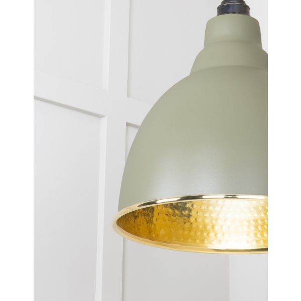 Close up of shade on hammered brass pendant light.