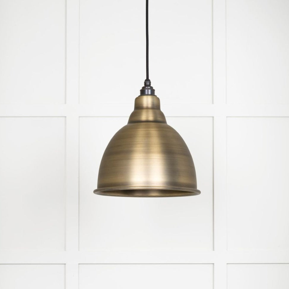 Aged brass pendant light switched off.