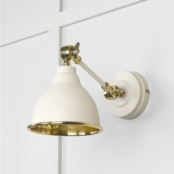 Teasal and brass hammered wall light, attached to white wall and switched off.