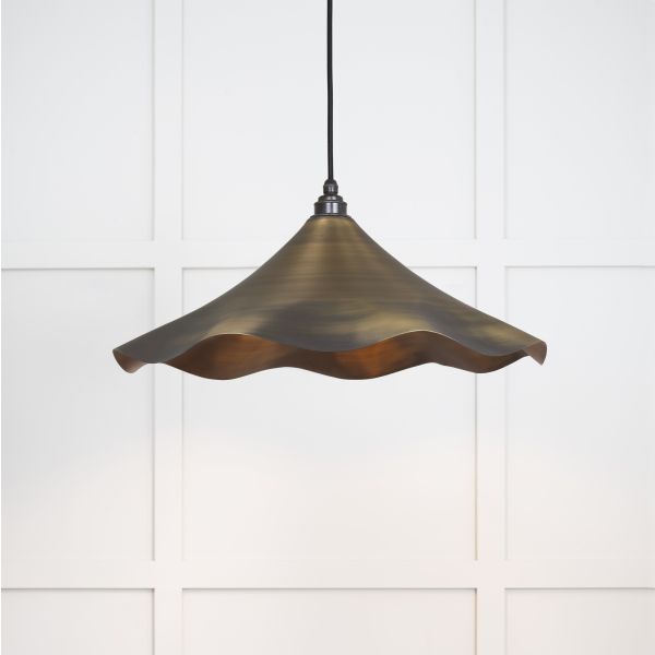 Aged brass flower shaped pendant light.