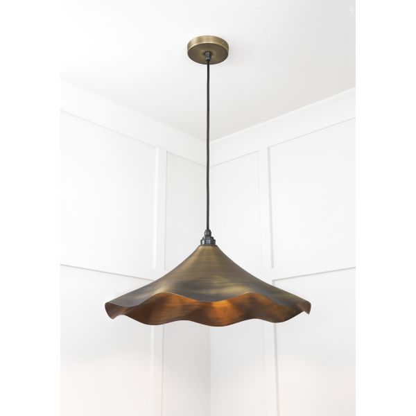 Aged brass flower shaped pendant light.