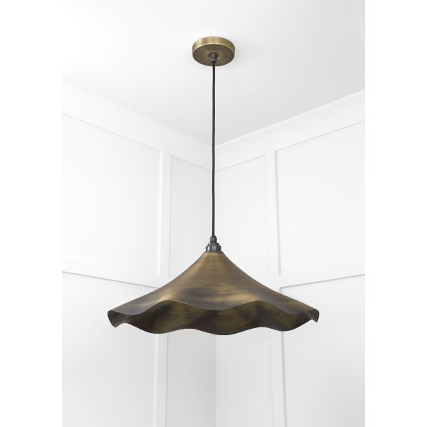 Aged brass flower shaped pendant light.