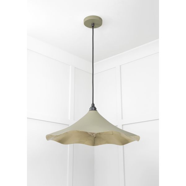 Floral brass and green pendant light, hanging from ceiling and switched off.