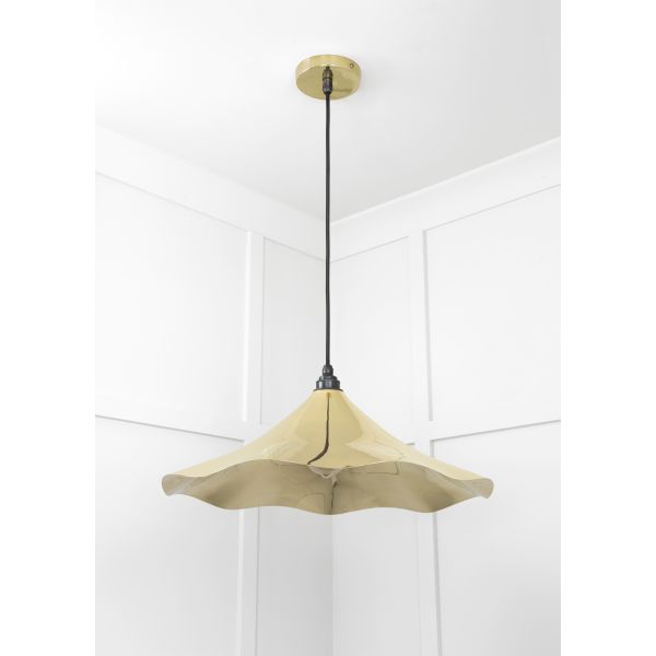 Floral shaped smooth brass pendant light, switched off.