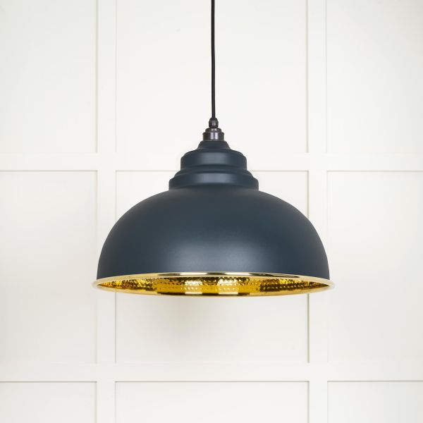 Shade on brass and black pendant light, switched off.