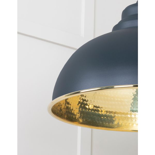 Close up of shade on brass and black pendant light.