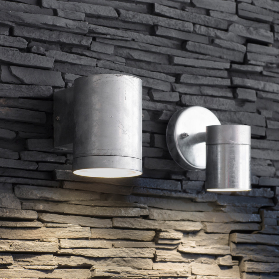 Two Galvanised Down Lights on a slate wall.