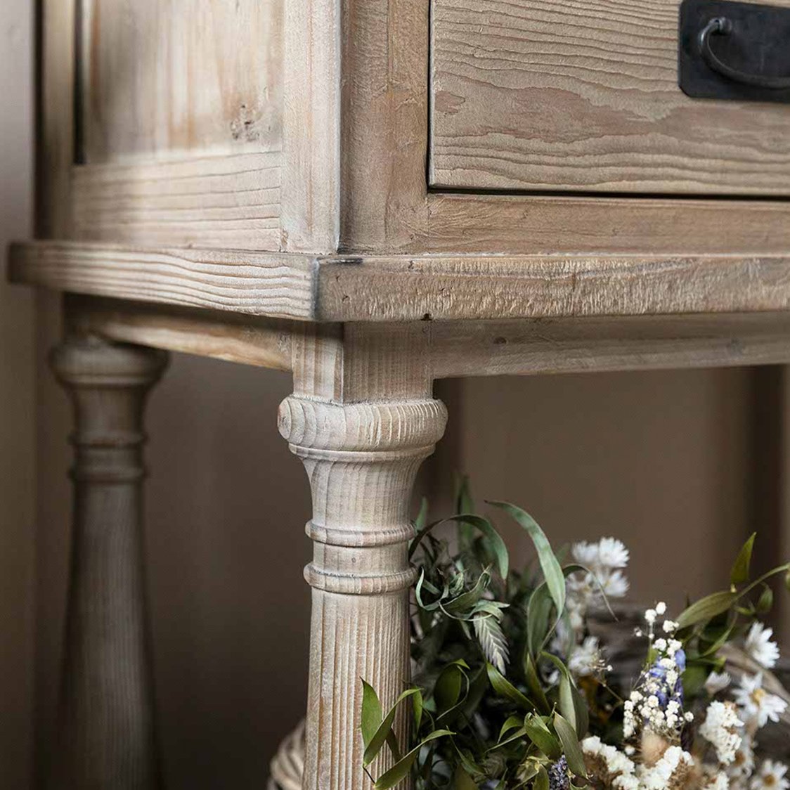 Detail shot of the Glass Display Cabinet with flowers.