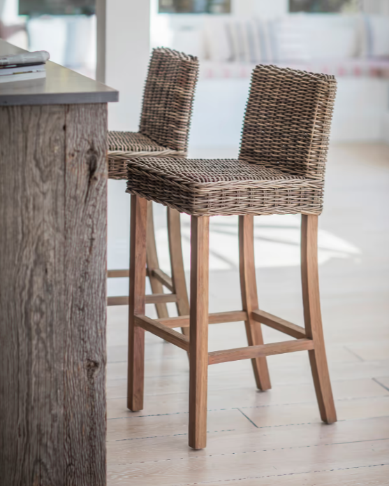 Farmhouse woven bar stool with back at breakfast bar.