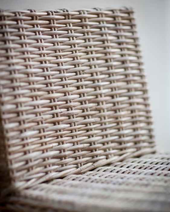 Close up of rattan seat on farmhouse woven bar stool.