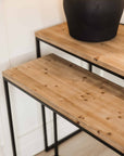 Close up of wooden finish on nest console tables.