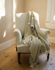 Natural waffle throw draped over armchair.