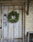 Green door wreath on barn door.