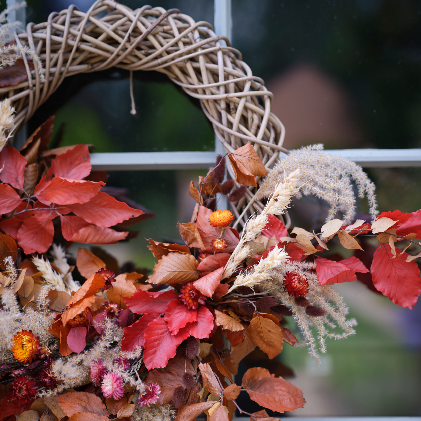 Autumn Wreath with orange foliage on front door.