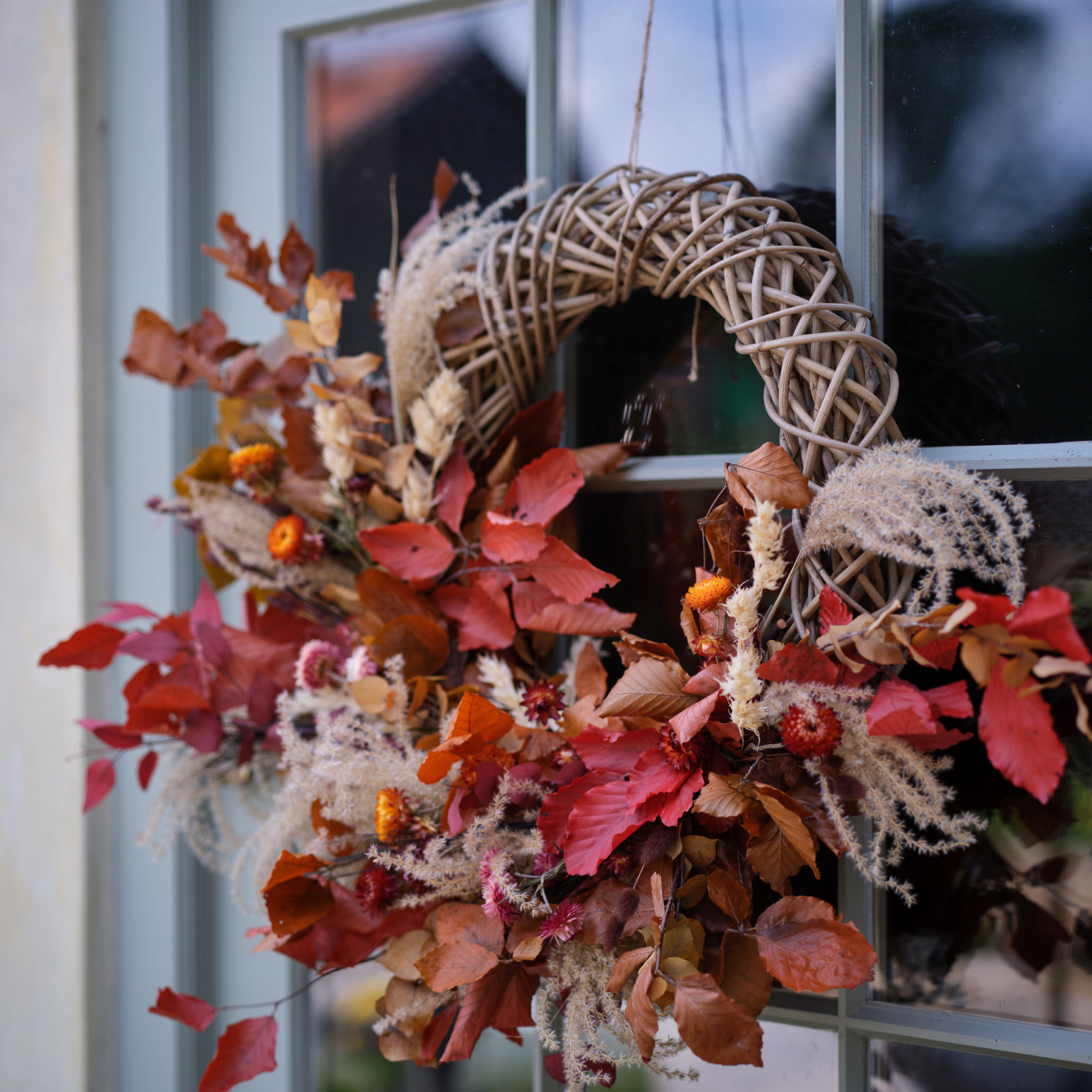 Autumn Wreath with orange foliage on front door.